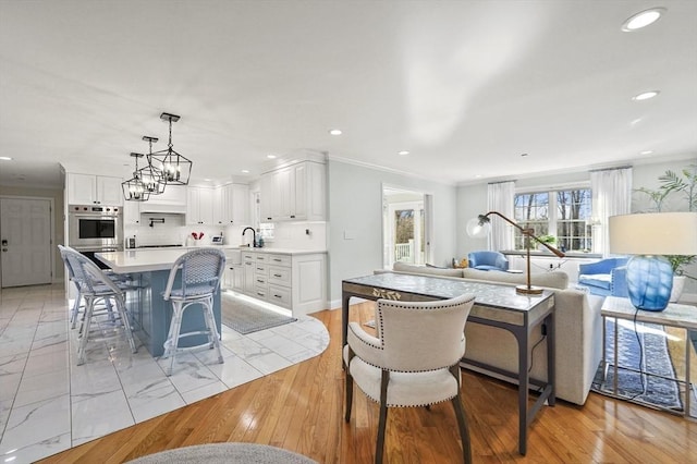 dining space featuring crown molding, a chandelier, and recessed lighting
