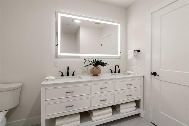 20 Audubon Way Unit 409, Canton, MA 02021 - bathroom with toilet, double vanity, and baseboards