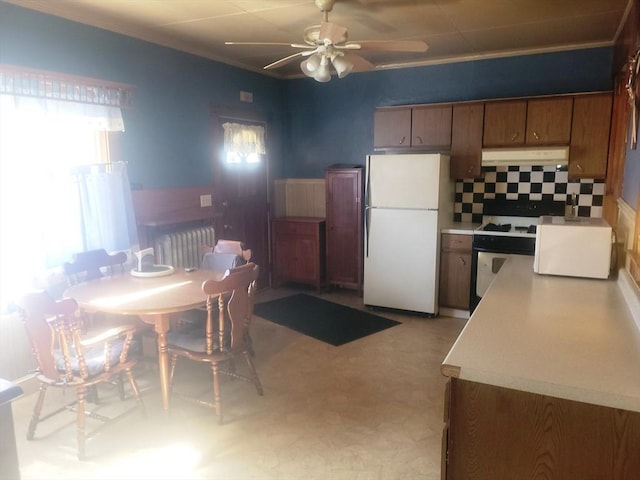 kitchen featuring under cabinet range hood, light floors, white appliances, brown cabinetry, and ceiling fan