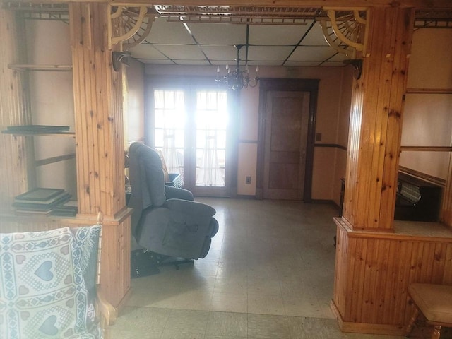 interior space featuring tile patterned floors and a paneled ceiling