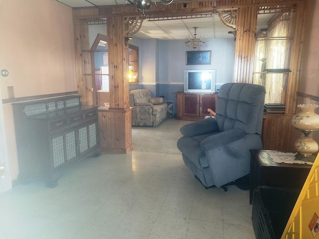 living room with tile patterned floors and a paneled ceiling