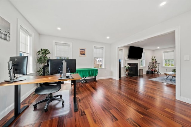 office with recessed lighting, baseboards, wood finished floors, and a fireplace