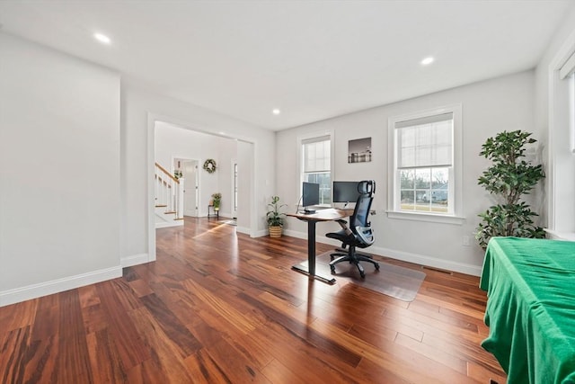 office space with recessed lighting, visible vents, baseboards, and wood finished floors