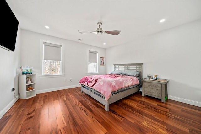 bedroom with visible vents, baseboards, and wood finished floors