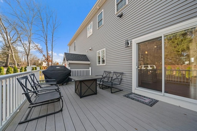 wooden deck with a grill