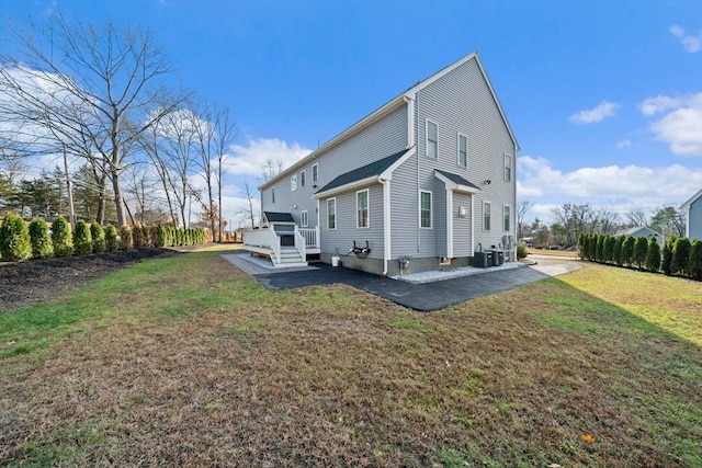 rear view of property with a patio area, central air condition unit, a lawn, and a wooden deck