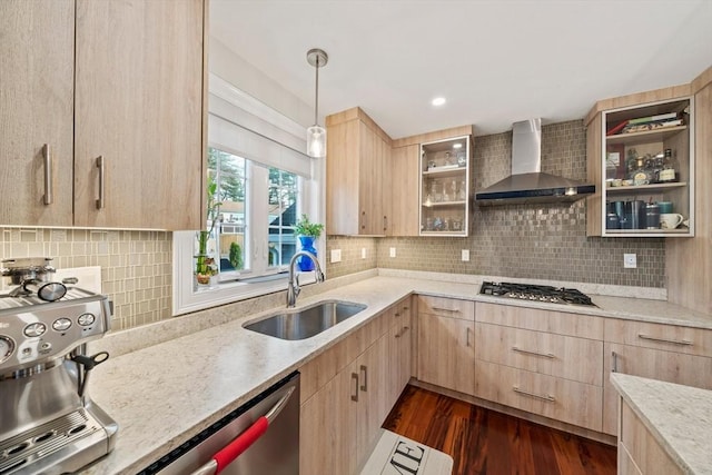 kitchen featuring a sink, wall chimney range hood, stainless steel appliances, and light brown cabinetry