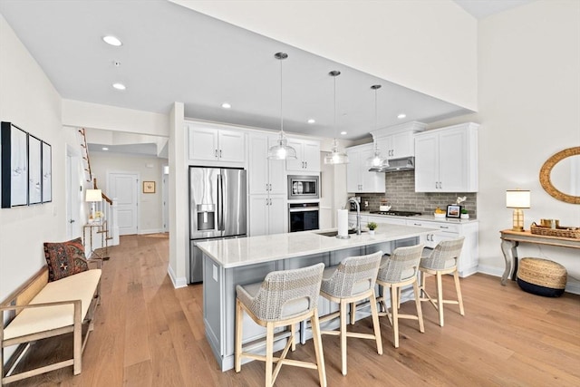 5 Diane Ter Unit 5, Scituate, MA 02066 - kitchen featuring appliances with stainless steel finishes, tasteful backsplash, light wood-style flooring, light countertops, and white cabinetry