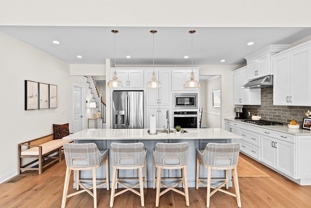 5 Diane Ter Unit 5, Scituate, MA 02066 - kitchen featuring appliances with stainless steel finishes, under cabinet range hood, backsplash, white cabinetry, and recessed lighting