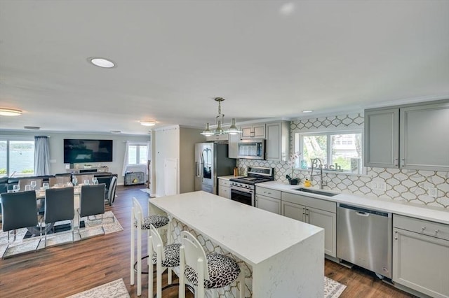 104 Kings Cove Beach Rd, Weymouth, MA 02191 - kitchen featuring stainless steel appliances, gray cabinetry, light countertops, tasteful backsplash, and a center island
