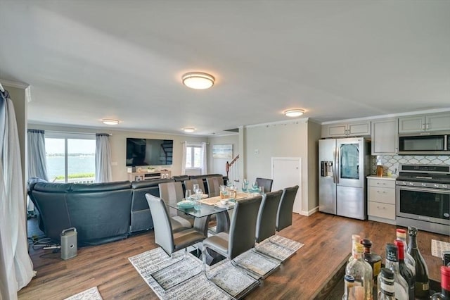 104 Kings Cove Beach Rd, Weymouth, MA 02191 - dining space with dark wood-style flooring and ornamental molding
