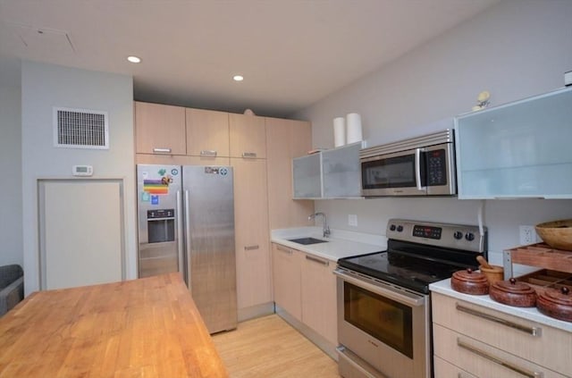 691 Massachusetts Ave Unit 102, Boston, MA 02118 - kitchen with stainless steel appliances, wooden counters, light brown cabinetry, light wood-style floors, and recessed lighting