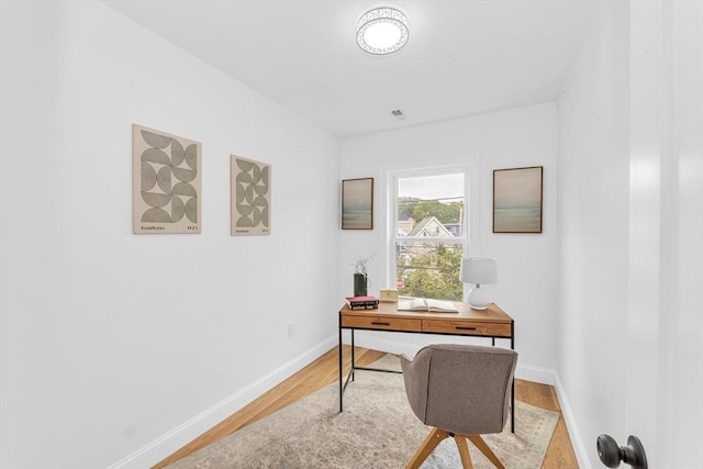 office area with light wood-type flooring and baseboards