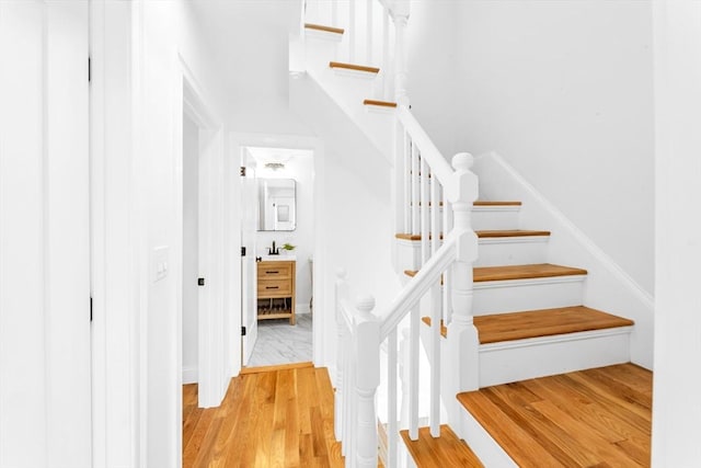 stairway with wood finished floors