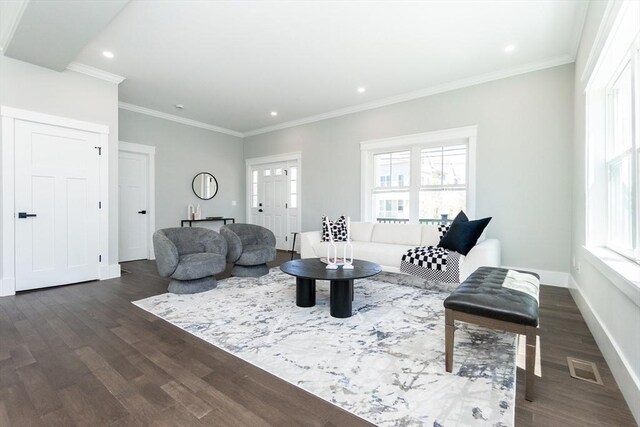 living room with visible vents, dark wood finished floors, crown molding, and a healthy amount of sunlight