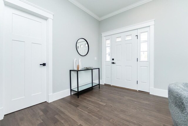 foyer with crown molding, baseboards, and dark wood-type flooring