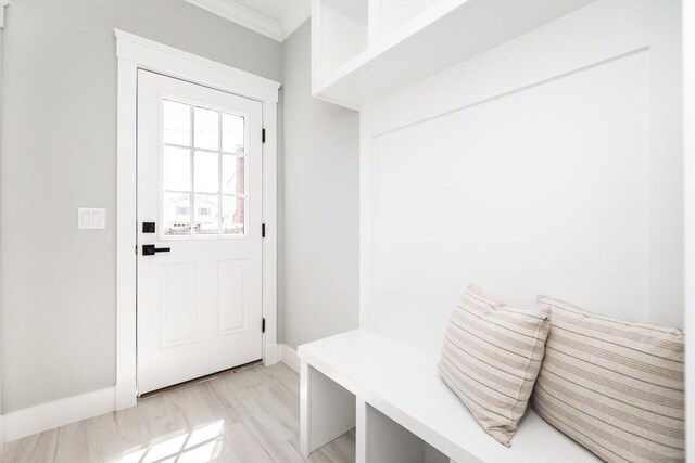 mudroom featuring baseboards and ornamental molding