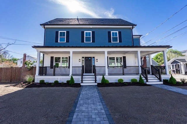 view of front of home featuring fence and covered porch
