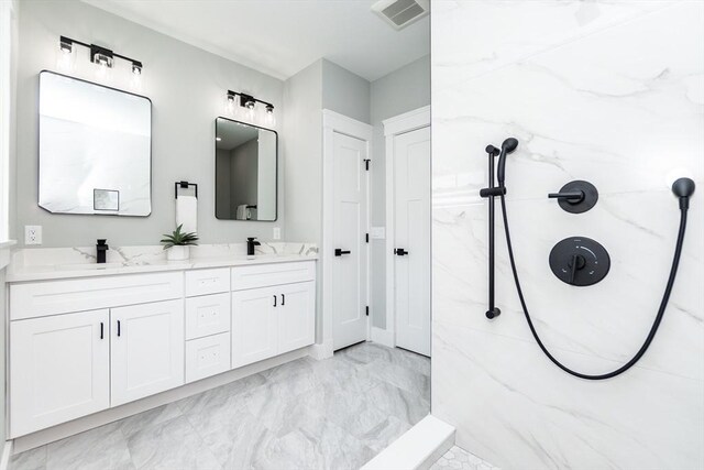 bathroom featuring double vanity, visible vents, a sink, marble finish floor, and a marble finish shower