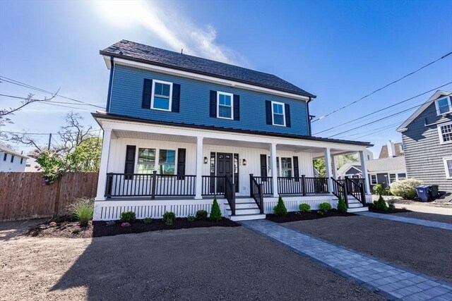 view of front of home featuring covered porch, fence, and board and batten siding