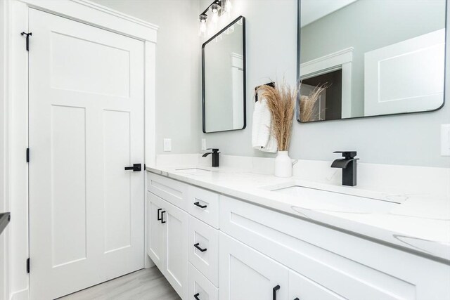 full bath with double vanity and a sink