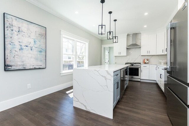 kitchen with a kitchen island, high quality appliances, light stone countertops, ornamental molding, and wall chimney exhaust hood