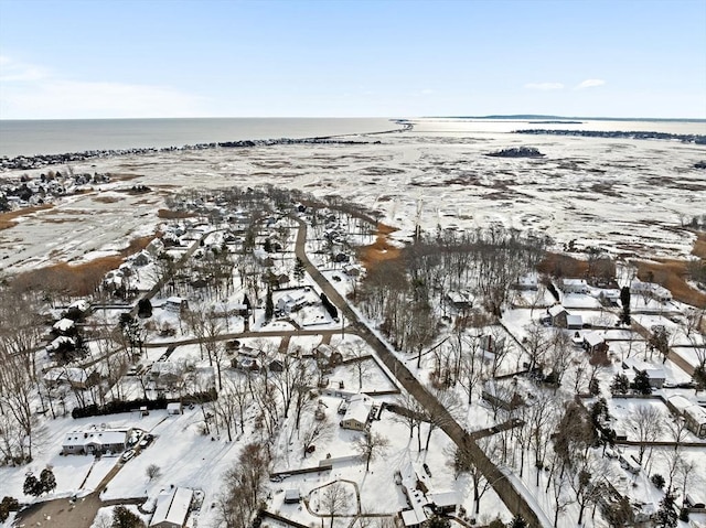 snowy aerial view featuring a water view