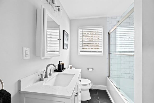 full bathroom with tile patterned floors, vanity, shower / bath combination with glass door, and a healthy amount of sunlight