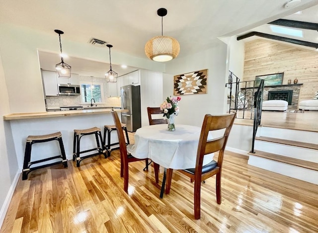 17 Brentwood Rd, Sudbury, MA 01776 - dining space with light wood-style floors, baseboards, visible vents, and stairway