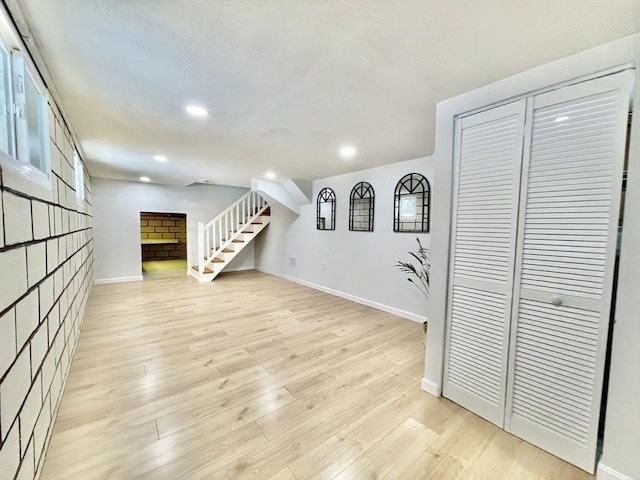 17 Brentwood Rd, Sudbury, MA 01776 - below grade area featuring recessed lighting, a fireplace, light wood finished floors, and baseboards