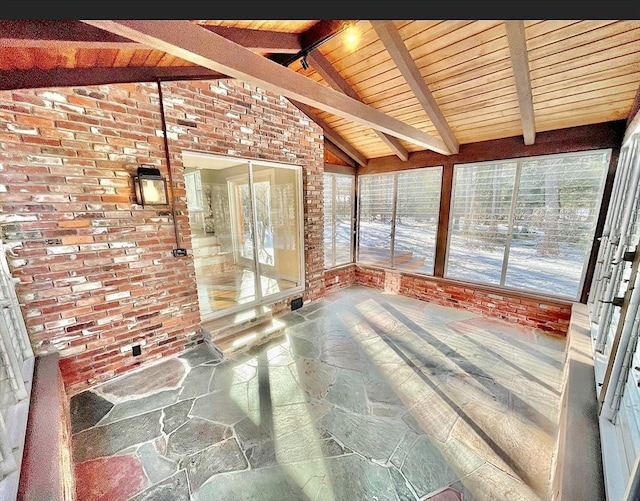 17 Brentwood Rd, Sudbury, MA 01776 - unfurnished sunroom featuring brick wall, stone flooring, lofted ceiling with beams, and wood ceiling