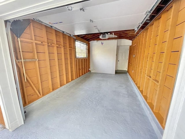 17 Brentwood Rd, Sudbury, MA 01776 - garage with a garage door opener and wood walls