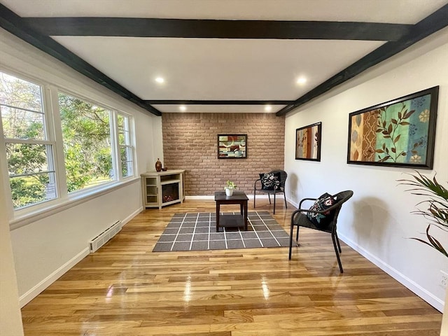 17 Brentwood Rd, Sudbury, MA 01776 - living area with visible vents, baseboards, brick wall, beam ceiling, and wood finished floors