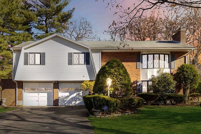 view of front facade featuring a lawn and a garage