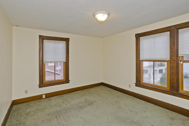 carpeted empty room with a healthy amount of sunlight