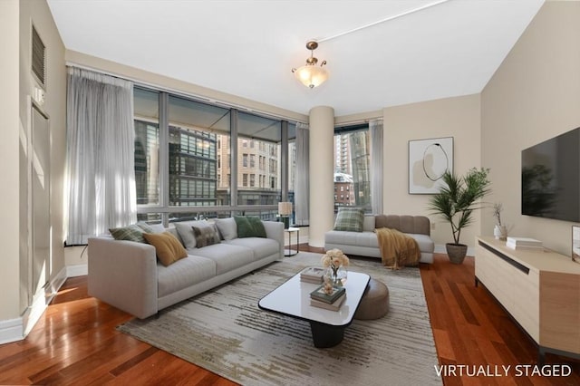 living area with visible vents and wood finished floors