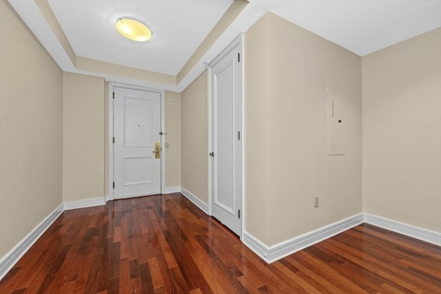 hall featuring baseboards and wood finished floors