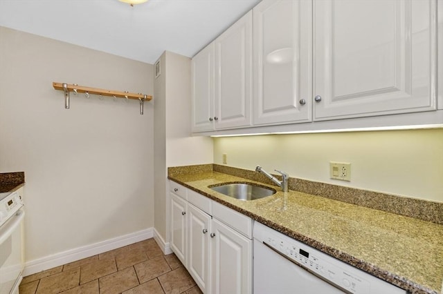 kitchen with a sink, stone counters, white appliances, and white cabinetry