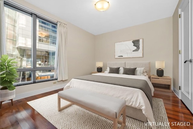 bedroom with baseboards and wood finished floors