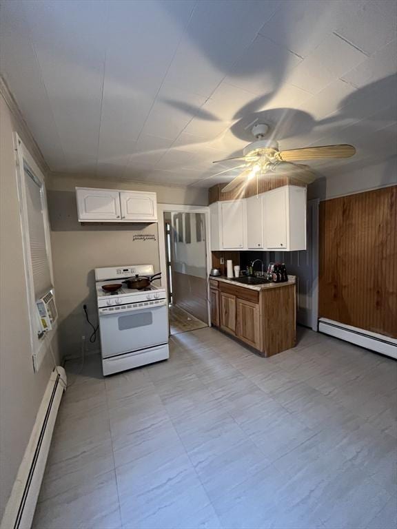 kitchen featuring baseboard heating, white range with gas cooktop, sink, and white cabinets