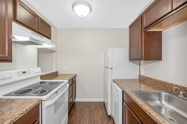 kitchen with brown cabinets, dark wood-type flooring, a sink, white appliances, and under cabinet range hood