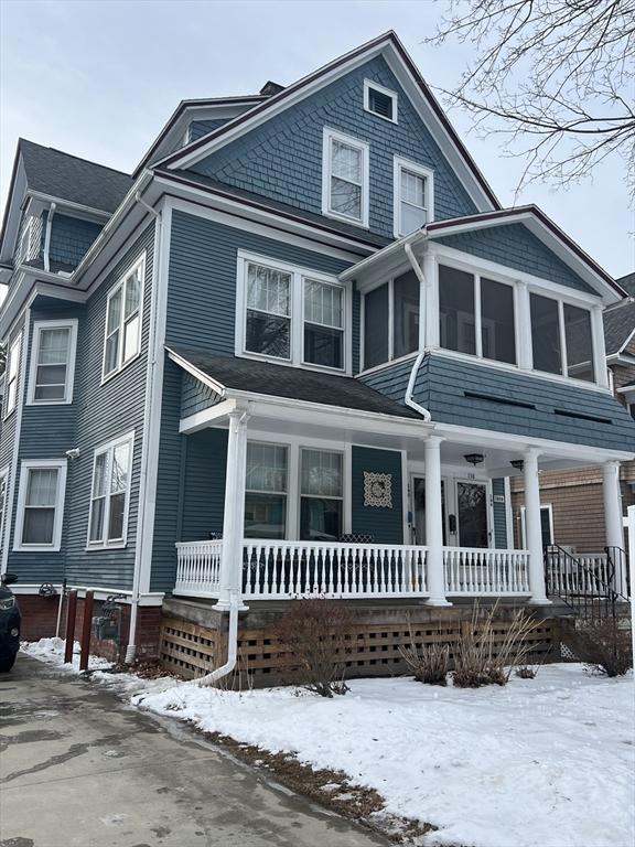 view of front of property featuring a porch and a sunroom