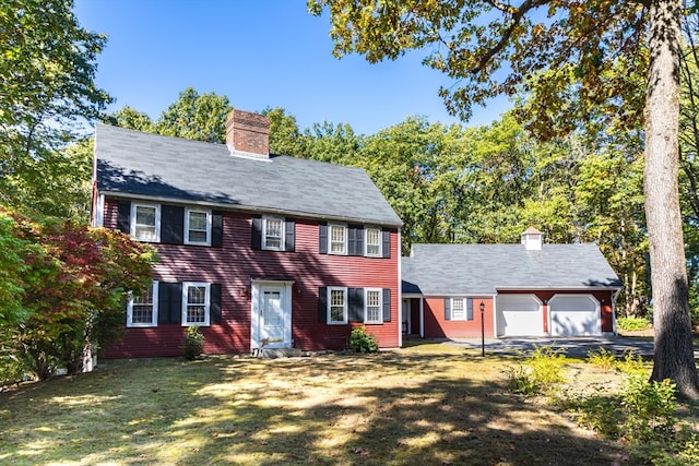 colonial-style house with a garage and a front lawn