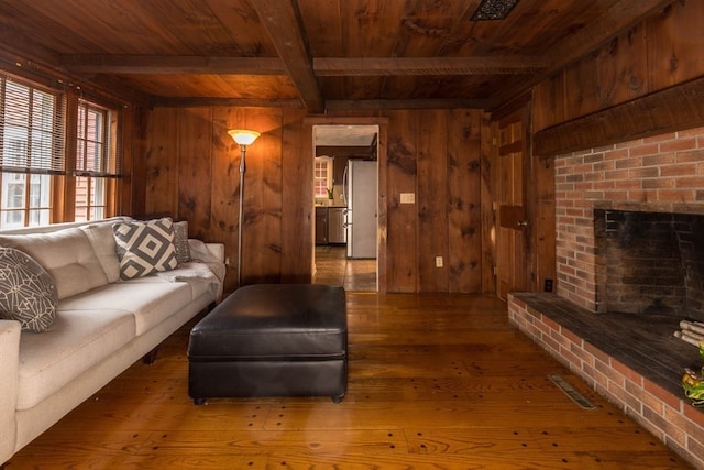 living room with dark wood-type flooring and wooden walls