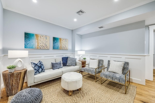 sitting room featuring light hardwood / wood-style floors and crown molding