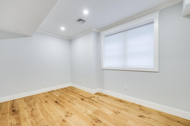 spare room with wood-type flooring and ornamental molding