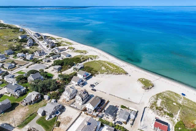 bird's eye view featuring a water view and a beach view