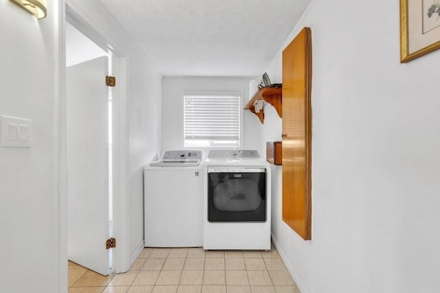 laundry room featuring light tile patterned floors and washer and clothes dryer