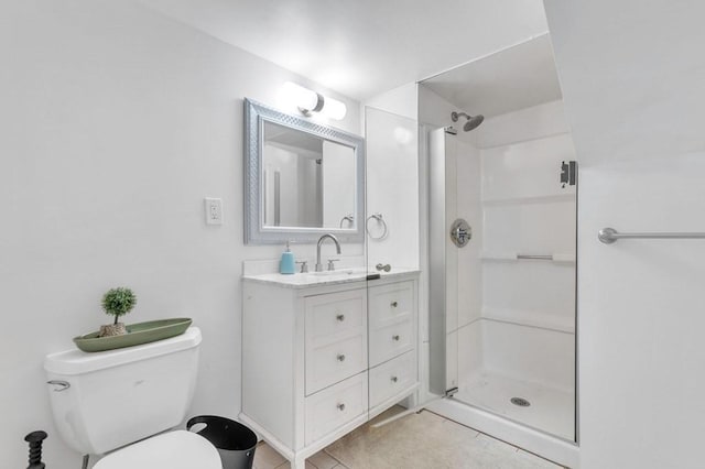 bathroom featuring tile patterned flooring, toilet, vanity, and walk in shower