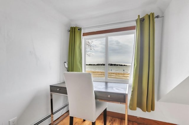 home office featuring a water view and light hardwood / wood-style floors